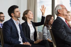 woman-meeting-with-raised-hand