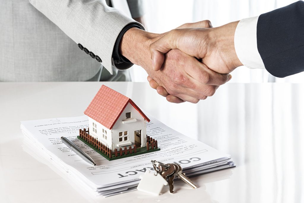 people-shaking-hands-toy-model-house